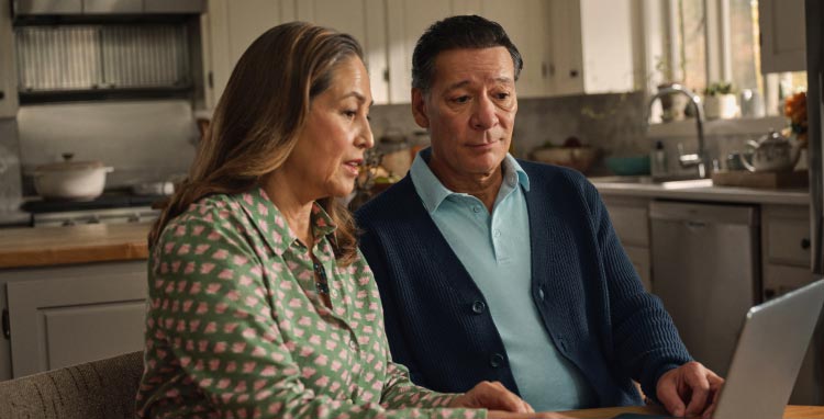 Patient and wife using a laptop. Actor portrayal