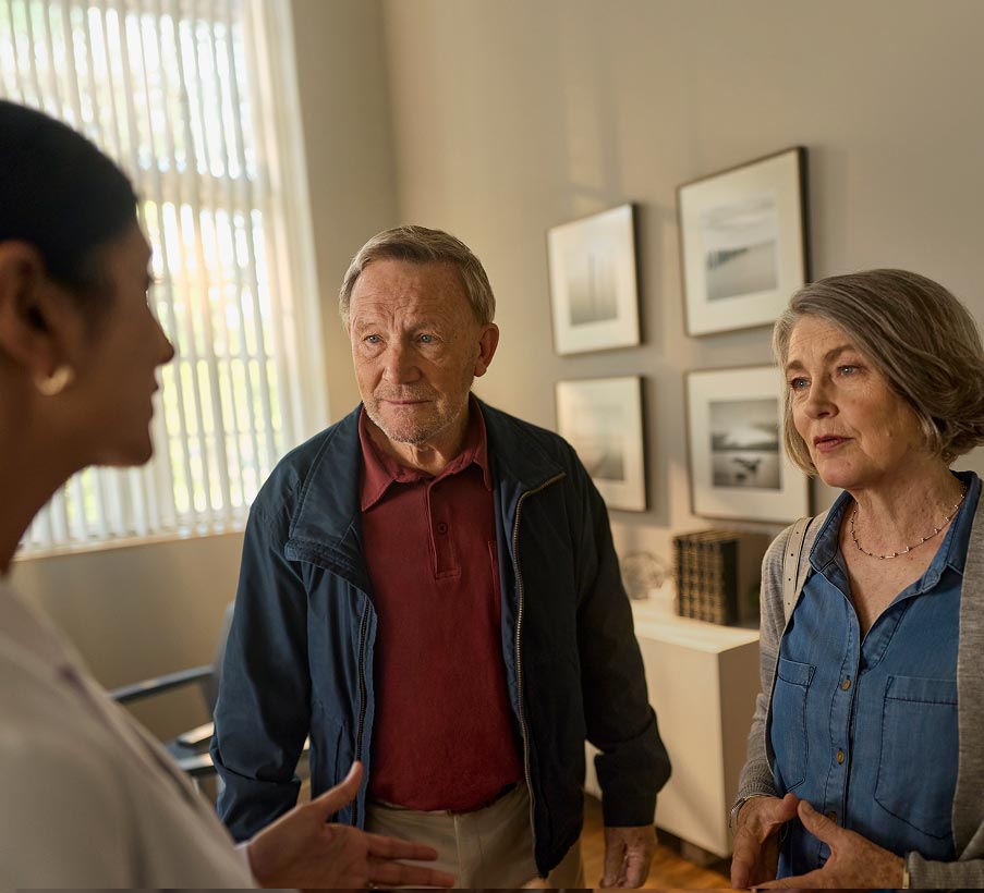 Patient and care partner talking to the doctor. Actor portrayal